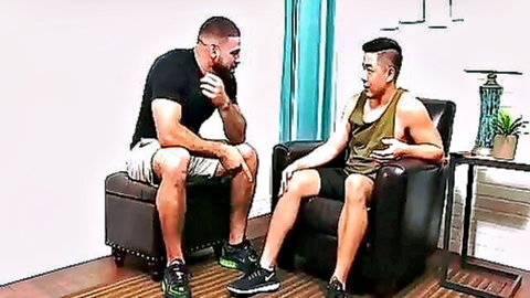 Muscular Asian jock and fit bearded guy in tank tops chatting intimately before foot play