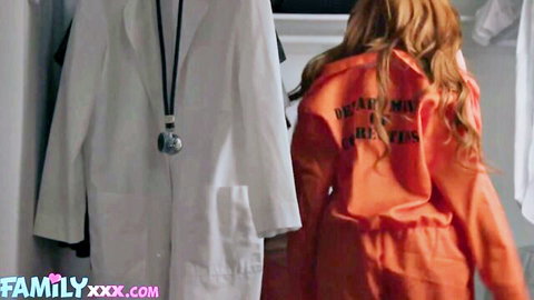 Redhead Lauren Phillips in orange prison jumpsuit, doctor coat nearby
