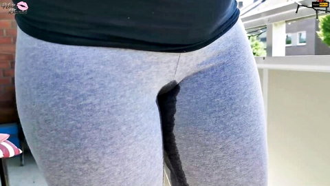 Woman in tight gray yoga pants with wet crotch stain cameltoe on balcony