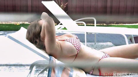 Kat Marie lounging topless in red polka-dot bikini by pool, big tits on display