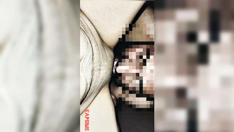 Blurry pixelated closeup of curvy woman's pale skin curves and hat-covered face in censored adult scene
