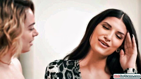 Sexy olive-skinned trans brunette in leopard top stares intensely at blonde cutie up close