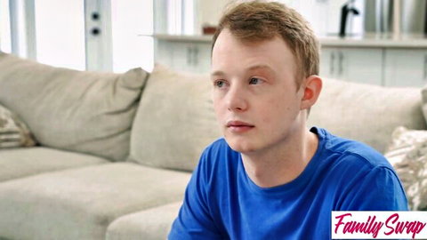 Blond stepson in blue tee sits pensively in Family Swap XXX MILF fantasy