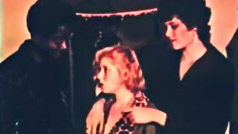 Vintage busty blonde in leopard dress with brunette and black man in intimate threesome pose