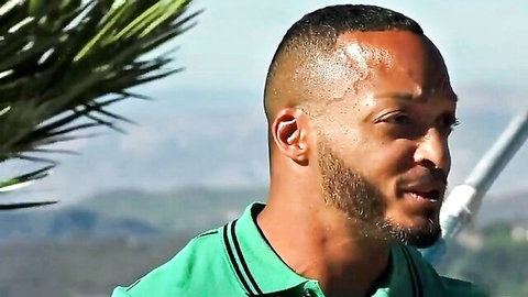 Handsome black male performer in green polo, outdoor promo for curvy brunette anal scene