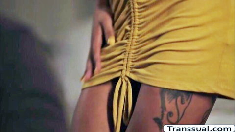 Latina shemale Camnair in tight yellow dress showing thigh tattoo