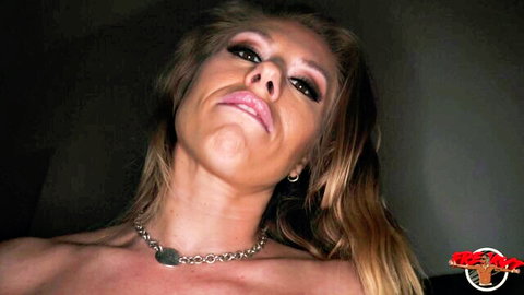 Blonde MILF grimacing in pleasure with silver chain collar closeup