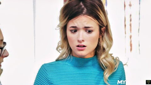 Shocked young blonde in tight turquoise sweater with wide eyes during taboo foreplay