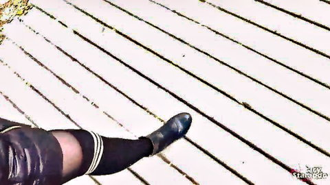 POV closeup of stepsister's legs in striped thigh-high stockings and boots on wooden deck