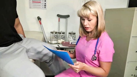 Blonde nurse in pink scrubs examines patient's exposed crotch in steamy medical POV exam