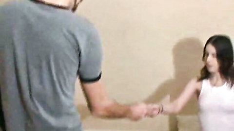 18yo brunette GF in white tank top holding hands intimately with boyfriend