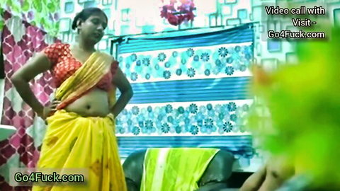 Indian mommy in yellow saree exposes midriff for foot fetish tease