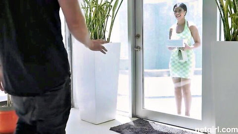 Ameena in sexy green dress smiling at door, teasing oral skills