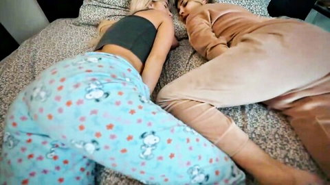 Two skinny blonde teens sleeping side by side in tight pajamas showing asses on bed