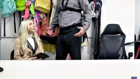 Blonde woman in store office sitting and looking up at man in harness holding bag