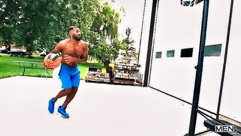 Shirtless tattooed ebony hunk dribbling basketball in blue shorts