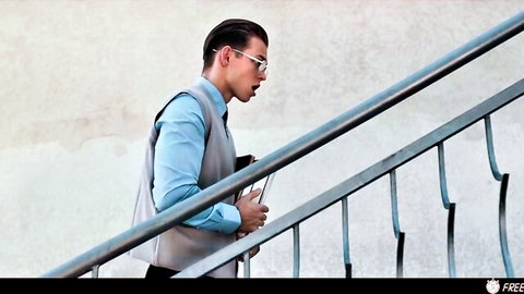 Tommy Gold in blue shirt and vest, walking up stairs professionally