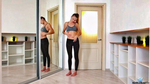 Elina De Leon in sports bra and leggings, teasing her fit body seductively