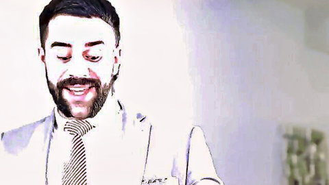 Handsome bearded man in suit smirking seductively for gay sensual encounter