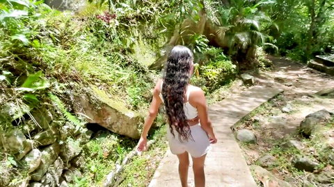 Sexy Latina babe with big ass in tight white shorts walking jungle path