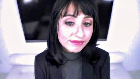 Daphne Dare close-up portrait in black blazer, seductive smile