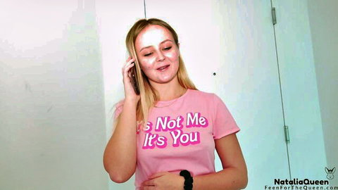 Natalia Queen blonde smiling on phone in pink It's Not Me It's You tee