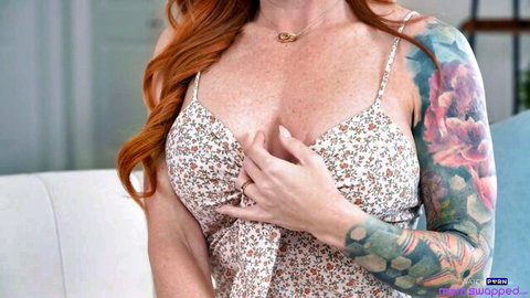 Sophia Locke redhead with tattoos in low-cut floral dress showing cleavage