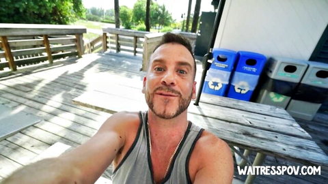 Hot DILF daddy in tank top takes smiling selfie on outdoor wooden deck