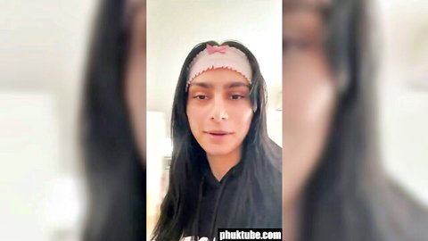 Sexy brunette babe with long hair and pink headband in hoodie selfie