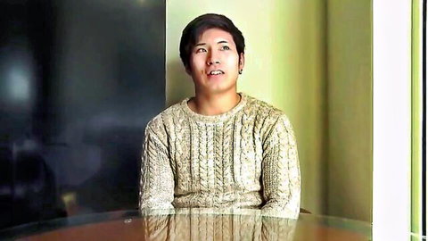 Japanese athlete Shoma in cream cable-knit sweater, sitting for interview