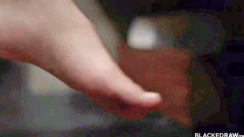 Pale bare foot arched and flexing over brown leather wallet in BLACKEDRAW scene