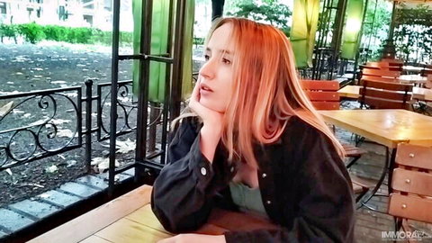 Polly Yangs looking pensively in black jacket and green top
