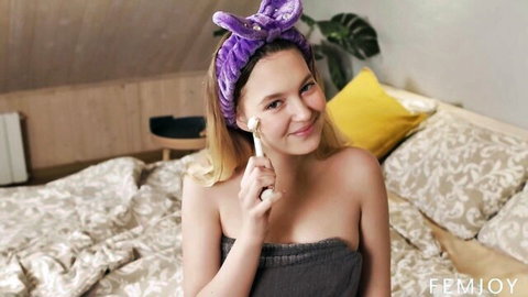 Nikoletta Queen smiling in solo beauty care with facial roller and bunny ears
