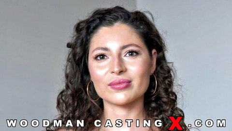 Curly haired brunette beauty puckers plump lips seductively in Woodman casting interview