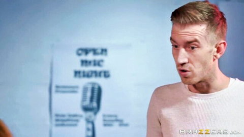 Muscular fair-skinned guy in tight white sweater with open mouth at open mic night Brazzers