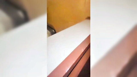 Blurry hotel bathroom sink with orange walls in Southeast Asian amateur scene