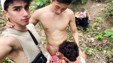 Three young shirtless Asian twinks teasing playfully outdoors in forest grabbing neck