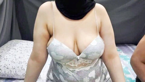 Hijabi Arab woman in sheer lace negligee teasing deep cleavage and huge tits