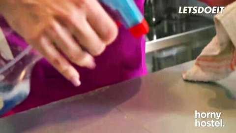 Sexy maid in purple thong bends over kitchen counter showing big round ass while spraying cleaner in horny hostel tease