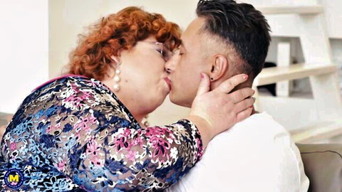 Busty redhead BBW mature passionately kissing young handsome guy