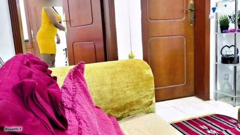 Curvy South Asian stepsis in tight yellow dress posing teasingly