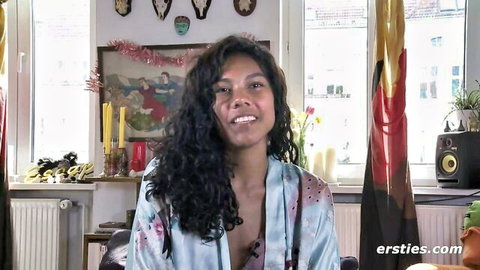 Curly haired skinny amateur smiles with open silk robe revealing deep cleavage and perfect medium tits