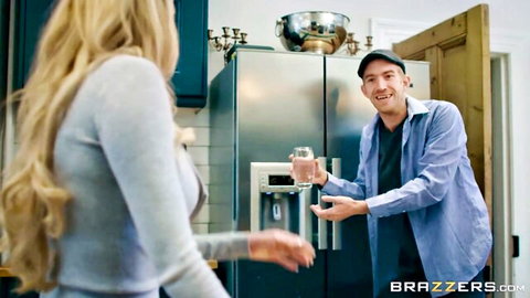 Busty blonde MILF in tight sweater turning for water from smiling guy in kitchen