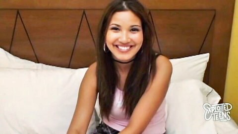 Smiling brunette teen in pink tank top on bed ready for exploited rough fuck