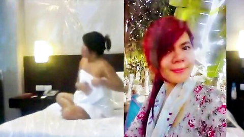 Sexy Thai amateur babe teasing in white towel on bed and smiling in floral robe closeup