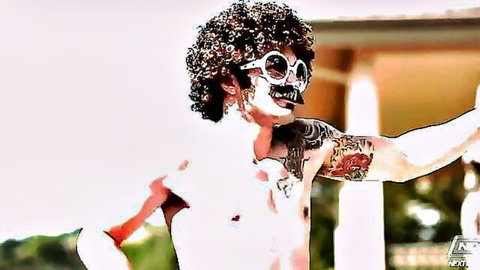 Shirtless tattooed hunk with wild afro, skull face paint and shades parties outdoors