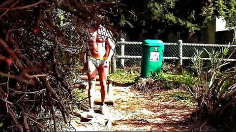 Danny Steele in white briefs with bulge outdoors near bushes