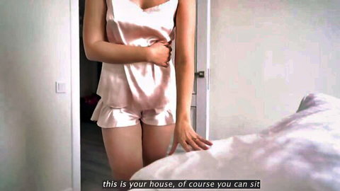 Ema Karter in pink silk pajamas teasing in doorway