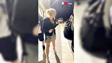 Blonde MILF in short skirt and sneakers at bus station, teasing kinky airport pickup