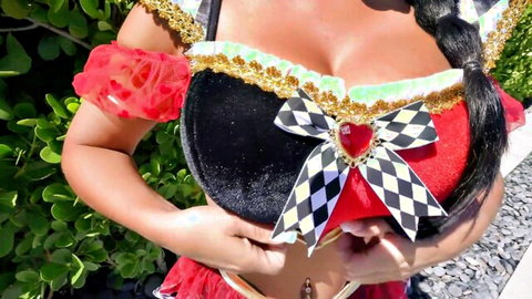 Miss Lexa in sexy Queen of Hearts costume, showing deep cleavage and curves